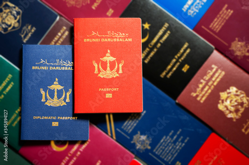 Diplomatic and national passports of Brunei Darussalam on a blurred background of different passports of world. photo
