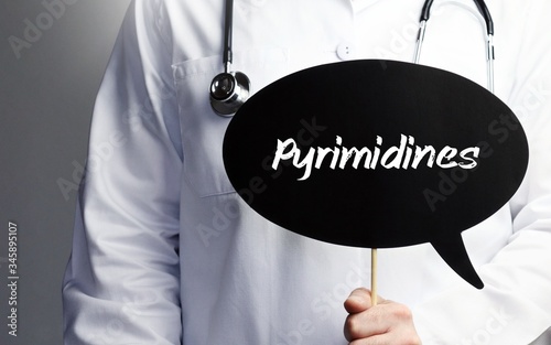 Pyrimidines. Doctor in smock holds up speech bubble. The term Pyrimidines is in the sign. Symbol of illness, health, medicine photo