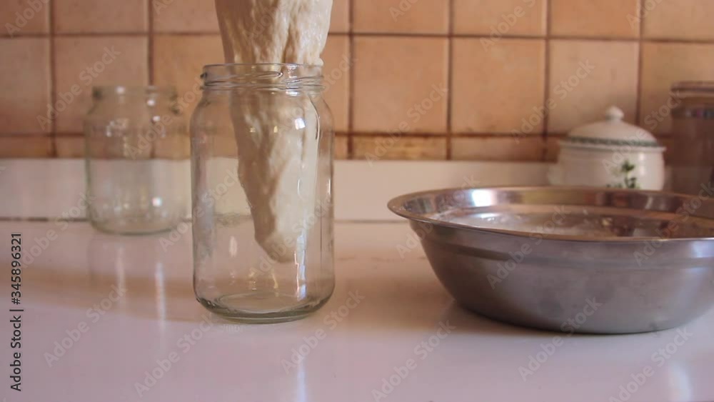 sourdough which is poured by pouring slowly into a transparent jar for the preparation of fermentation sourdough which is poured by pouring slowly into a transparent jar for the preparation of fermentation