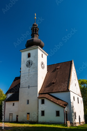 Church of the Nativity of the Virgin Mary Cetviny (Zettwing czech village). Sunny summer day with white chapel cathedral. Sumava, Bohemian Forest, Böhmerwald, Gratzen Mountains, Czech Republic.