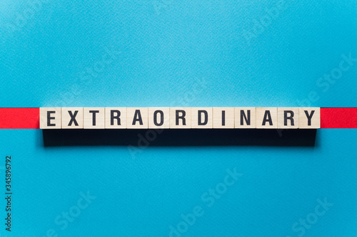 Extraordinary word concept on cubes photo