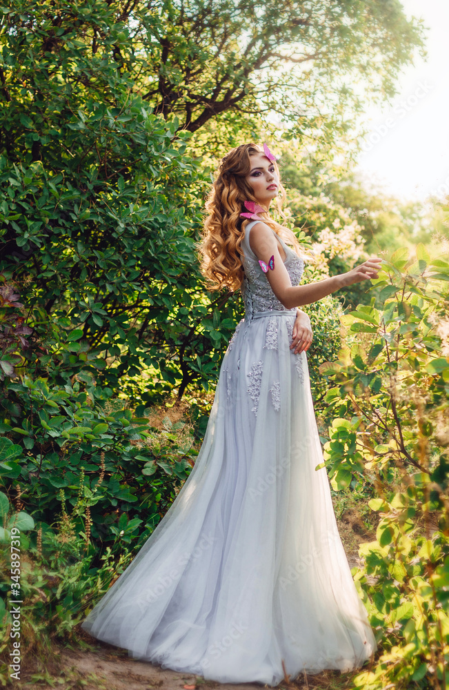 fairy girl Dryad with red hair with butterflies in nature in the forest sunset fairy girl Dryad with red hair with butterflies in nature in the forest sunset
