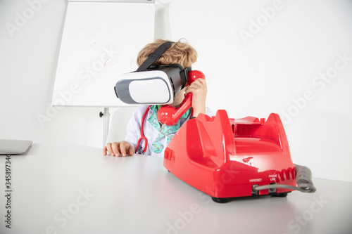 young doctor in virtual reality goggles talking on the phone, a symbol of globalization