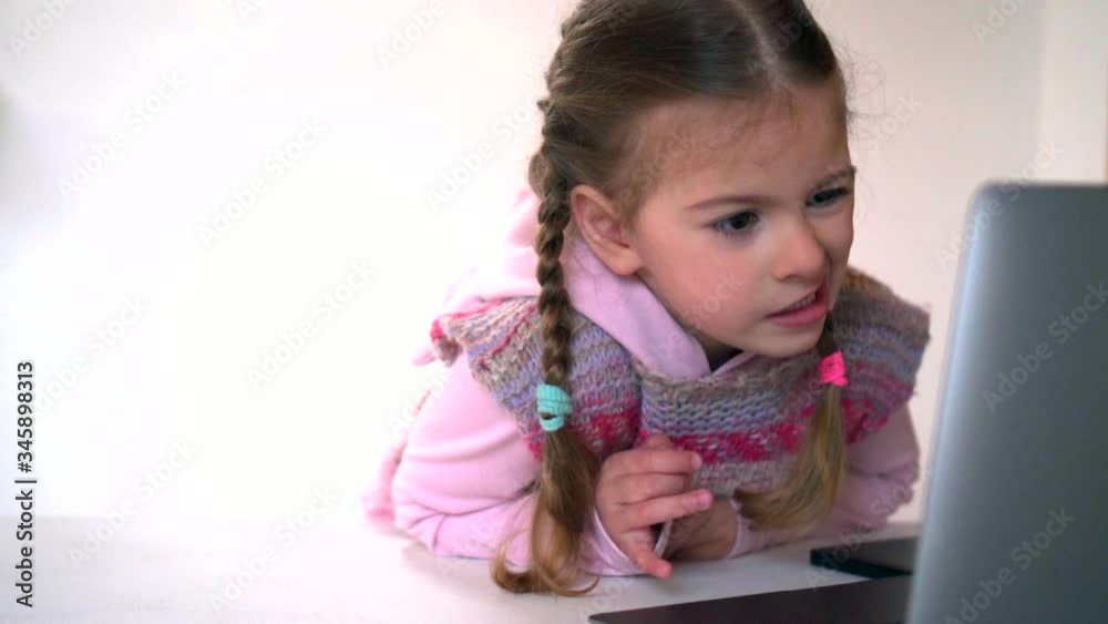Distance learning. Online school and little girl watching. Home isolation and online lessons. Quarantine and schooling. Distance learning. Online school and little girl watching. Home isolation and online lessons. Quarantine and schooling.