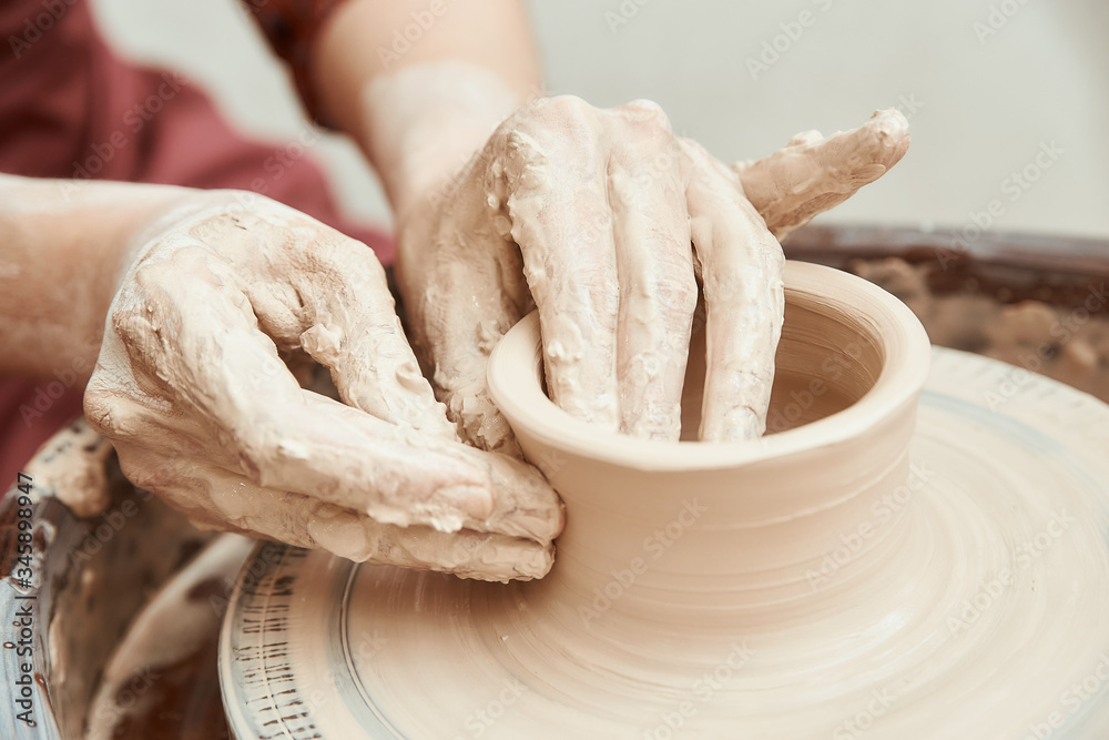 clay modeling on a Potter's wheel hands close up