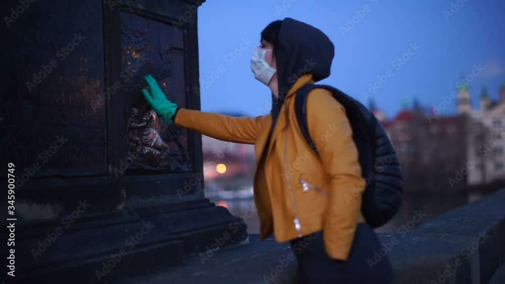 Tourist in medical mask, gloves take a wish about world fight with pandemic. Popular touristic point. State of emergency and public quarantine, viral epidemic outbreak Biohazard сlothing colors