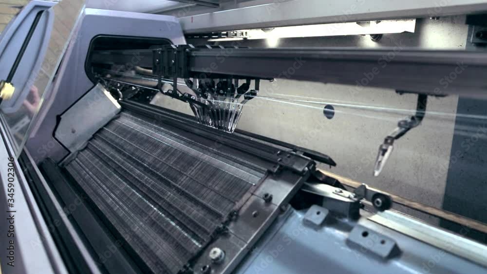 Wide shot of weaving machine working. Wide shot of weaving machine working.