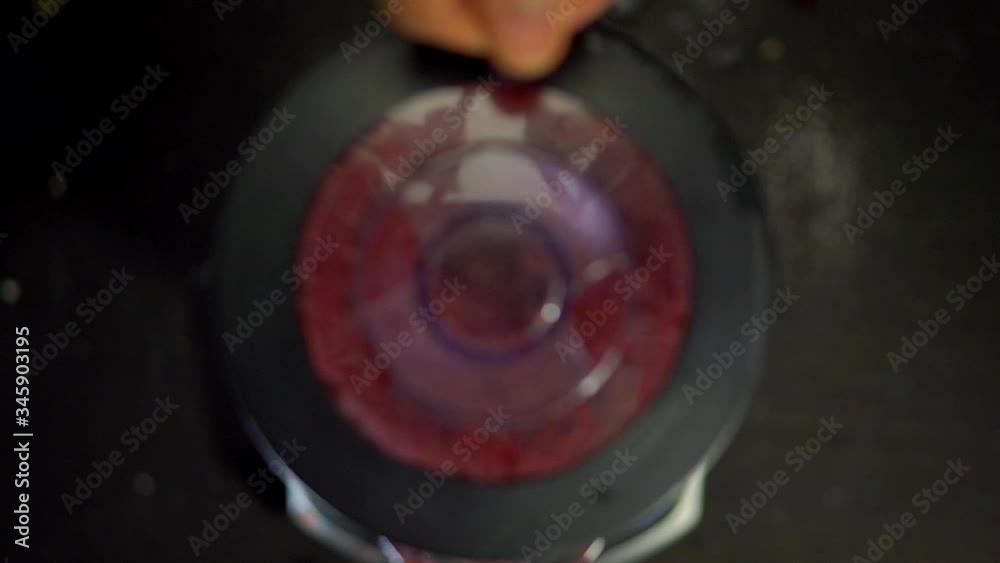 Remove the lid from the working blender. A bright red liquid swirls and turns. The view from the top. Ingredients for making smoothies. Pain smoothie in the mixer. Healthy food and drink from vegetabl Remove the lid from the working blender. A bright red liquid swirls and turns. The view from the top. Ingredients for making smoothies. Pain smoothie in the mixer. Healthy food and drink from vegetabl