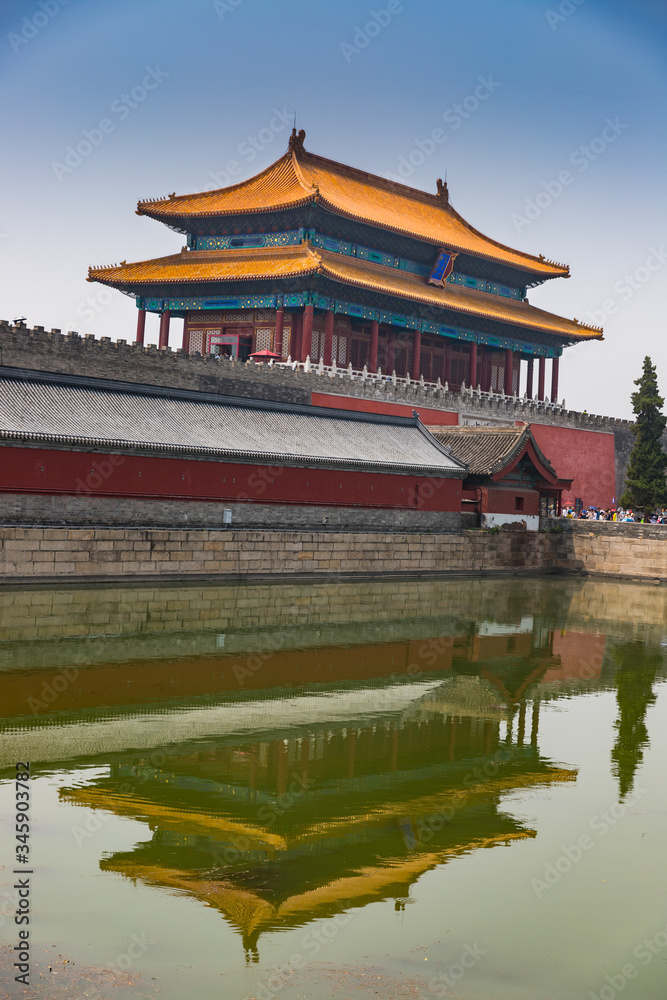 Reflections of a building outside the Forbidden City landmark in Beijing, China on a summer day