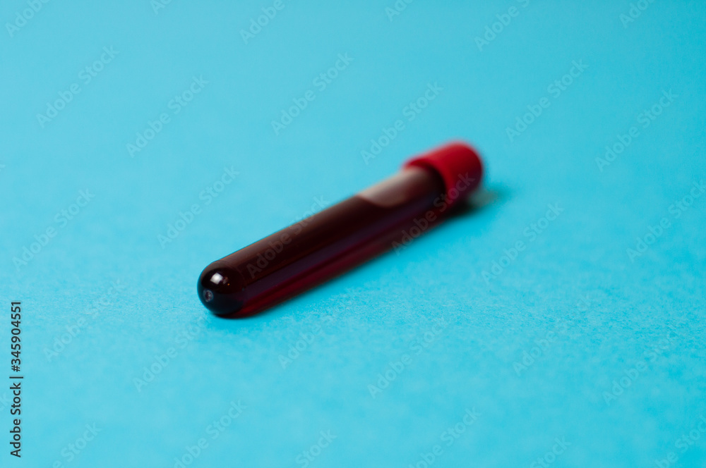 Test tube with blood isolate on a blue background Test tube with blood isolate on a blue background