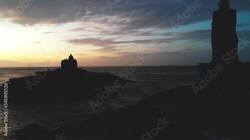 Thiruvalluvar Statue During Sunrise. The statue was built in the memory of this great man and stands atop a small island rock, about four hundred metres away from the coastline of Kanyakumari. photo