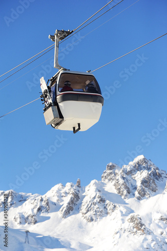 Ski lift over European alps, in ski valley Courchevel by winter 