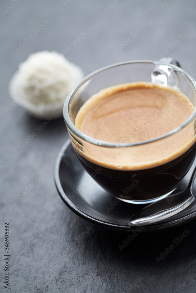 Coffee in glass cup on dark stone background. Close up. Coffee in glass cup on dark stone background. Close up.
