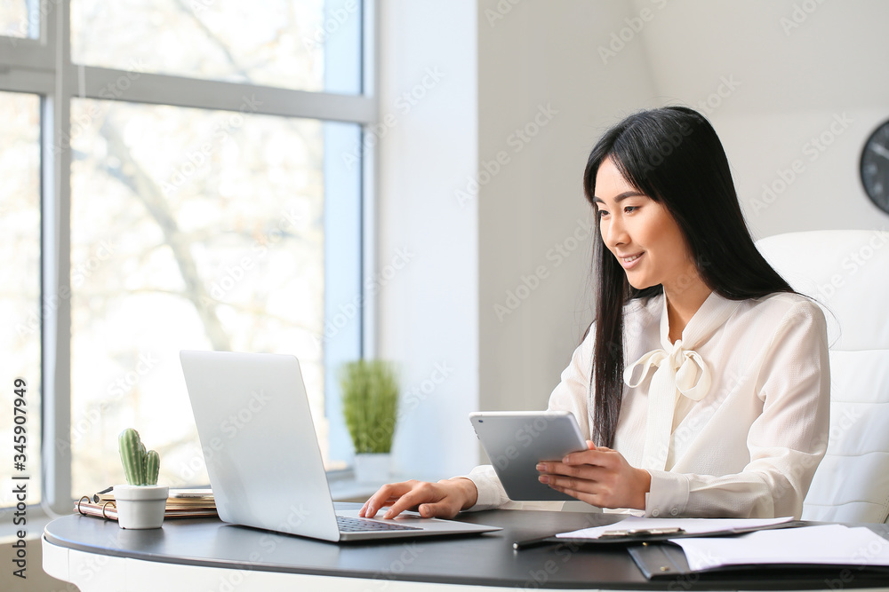 Beautiful Asian secretary working in office Beautiful Asian secretary working in office
