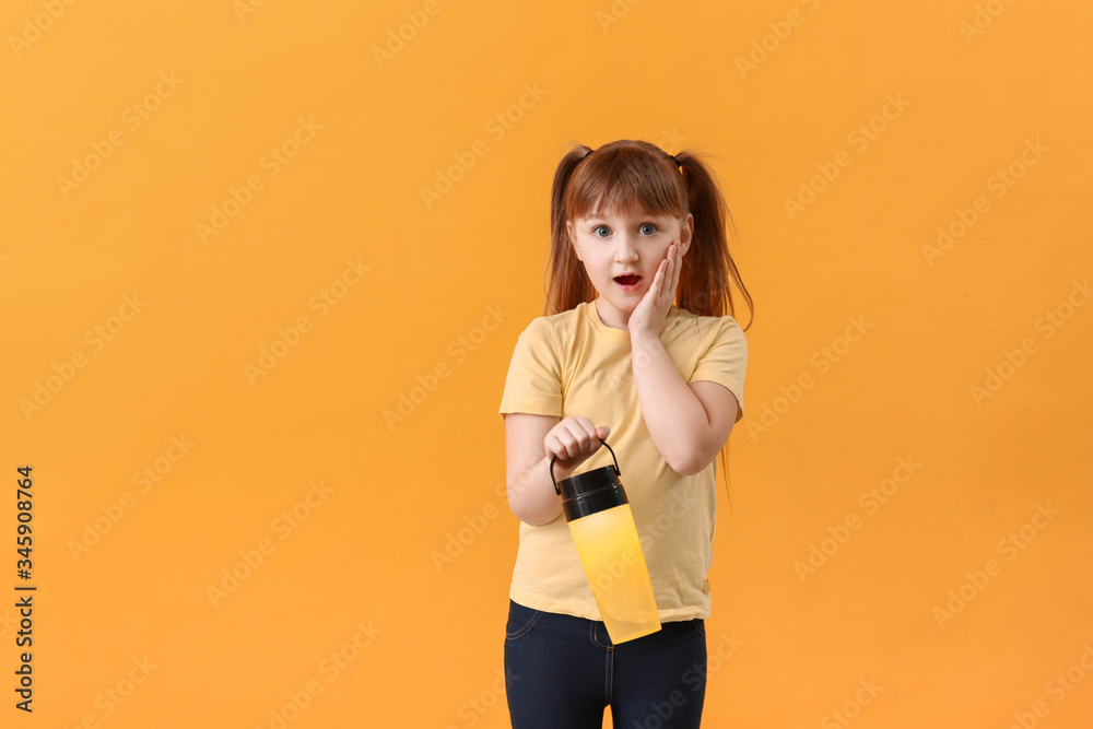 Surprised little girl with flashlight on color background