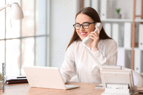 Beautiful young secretary working in office