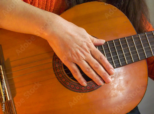 Simple guitar chords, woman playing acoustic guitar, close up photography