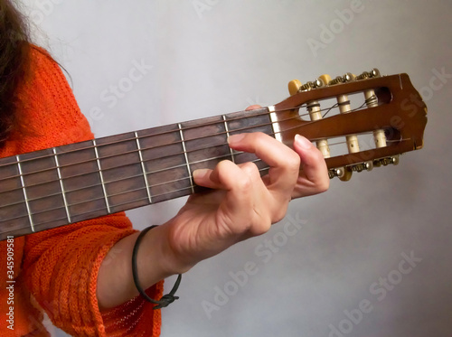 Simple guitar chords, woman playing acoustic guitar, close up photography