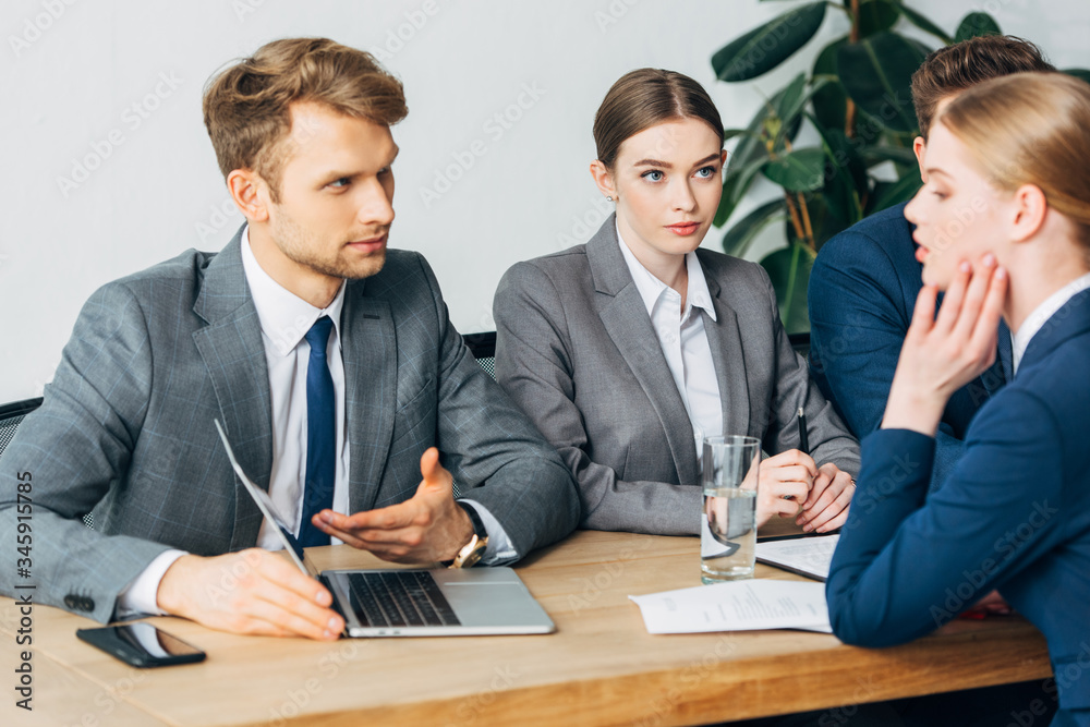 Selective focus of recruiters looking at employee during job interview Selective focus of recruiters looking at employee during job interview