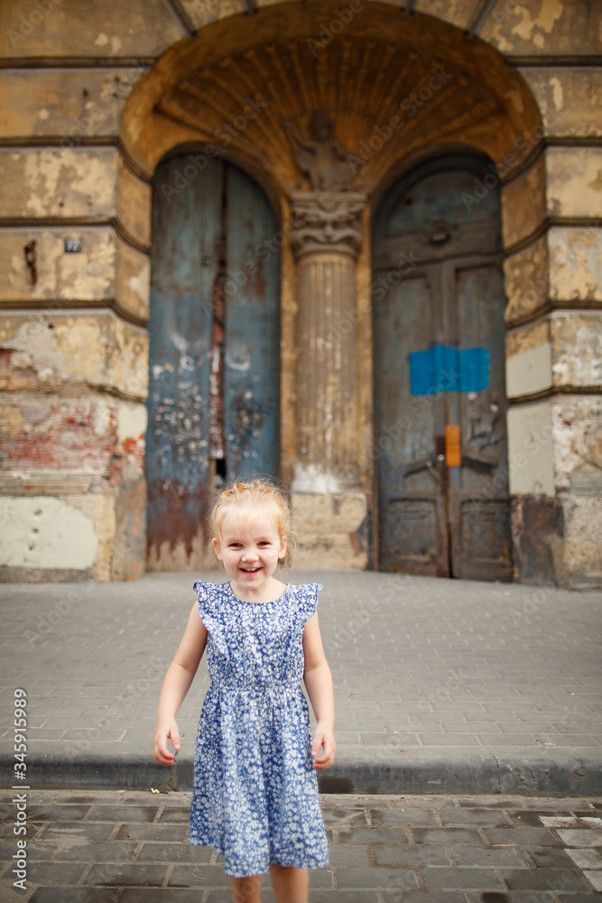 little happy girl in background of old door little happy girl in background of old door