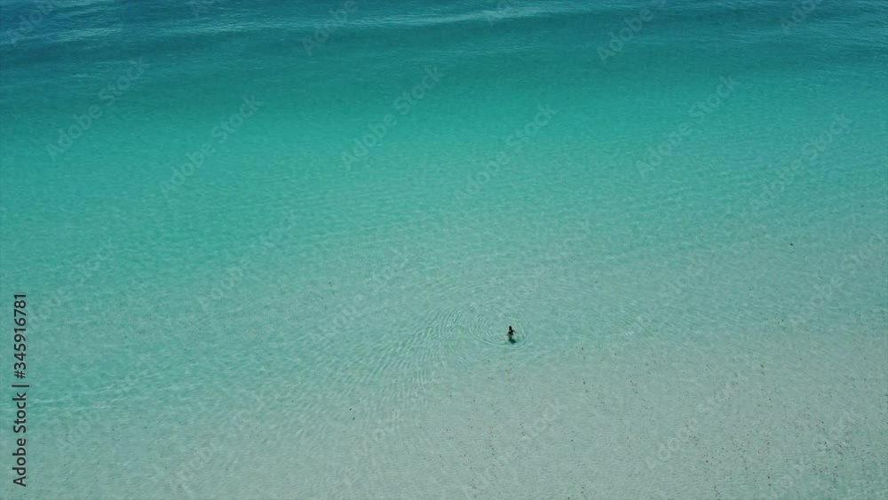 One Person alone in Paradise in Blue Water One Person alone in Paradise in Blue Water