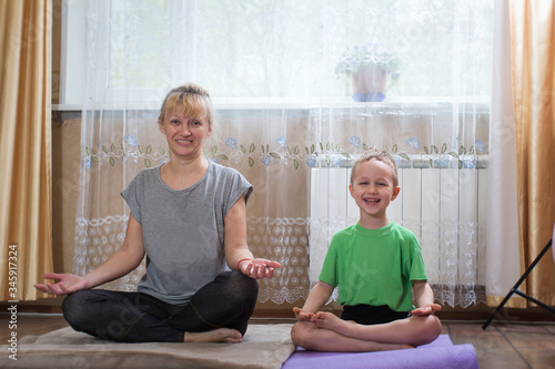 in quarantine, grandmother and grandson do joking yoga