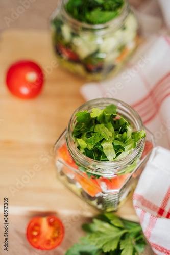 Healthy Homemade Jar Salad with cucumbers and tomatoes. Healthy food, Diet, Detox, Clean Eating or Vegetarian concept.