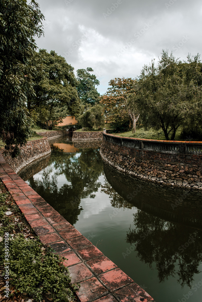 Fototapeta premium Hue, Vietnam – 27 July 2019: Temple in the Imperial City (citadel) of Hue (UNESCO World Heritage site). The place that leads to the palaces of kings, is the official in the 19th century in Hue, Vietna