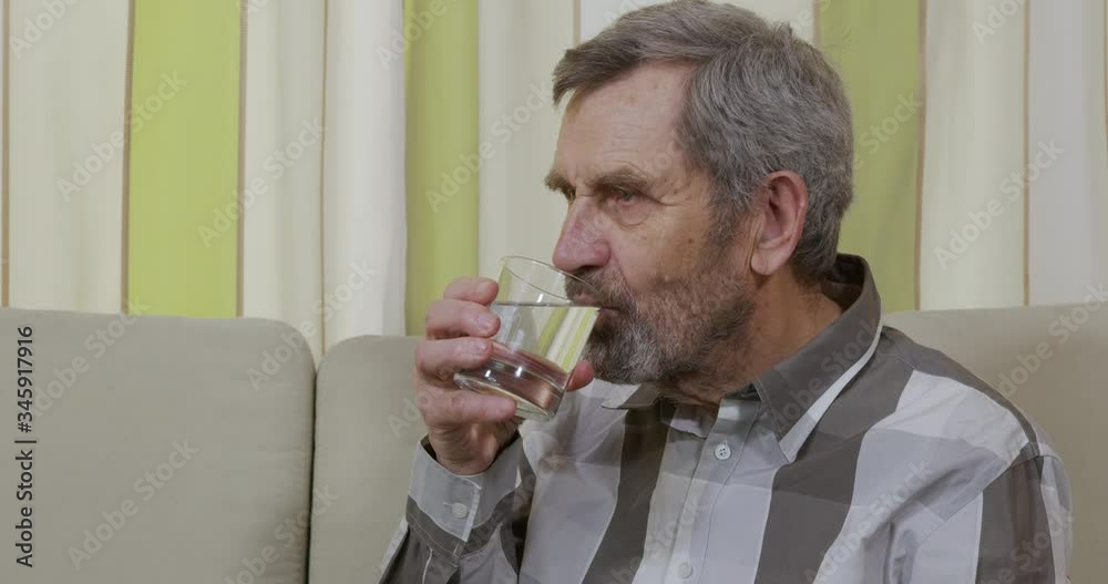 Elderly man drinking a glass of water. Elderly man drinking a glass of water.