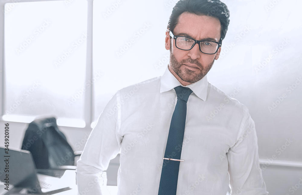 Fototapeta premium confident businessman standing in a spacious office