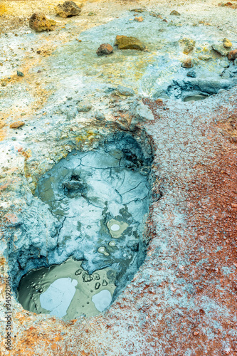 Fototapeta Naklejka Na Ścianę i Meble -  Multi colored bubbling hot pool and colorful soil , rocks and dirt in geothermal and volcanic area in Iceland. Texture and pattern concept.