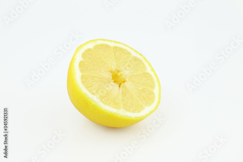 Half of ripe fresh lemon isolated on white background. Yellow fresh sliced lemon separated on white background
