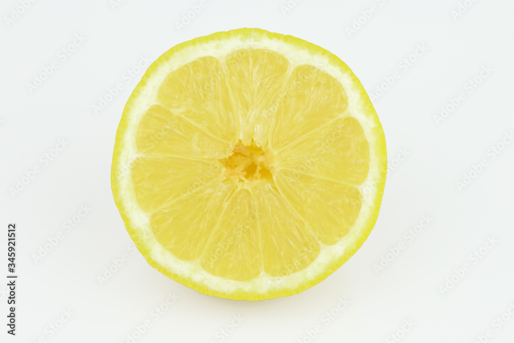 Half of ripe fresh lemon isolated on white background. Yellow fresh sliced lemon separated on white background