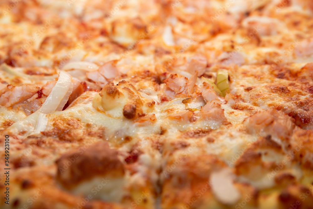 A closeup of delicious BBQ homemade pizza with double cheese, chicken, onion and bacon. Intense colors. Food background concept. With place for text A closeup of delicious BBQ homemade pizza with double cheese, chicken, onion and bacon. Intense colors. Food background concept. With place for text