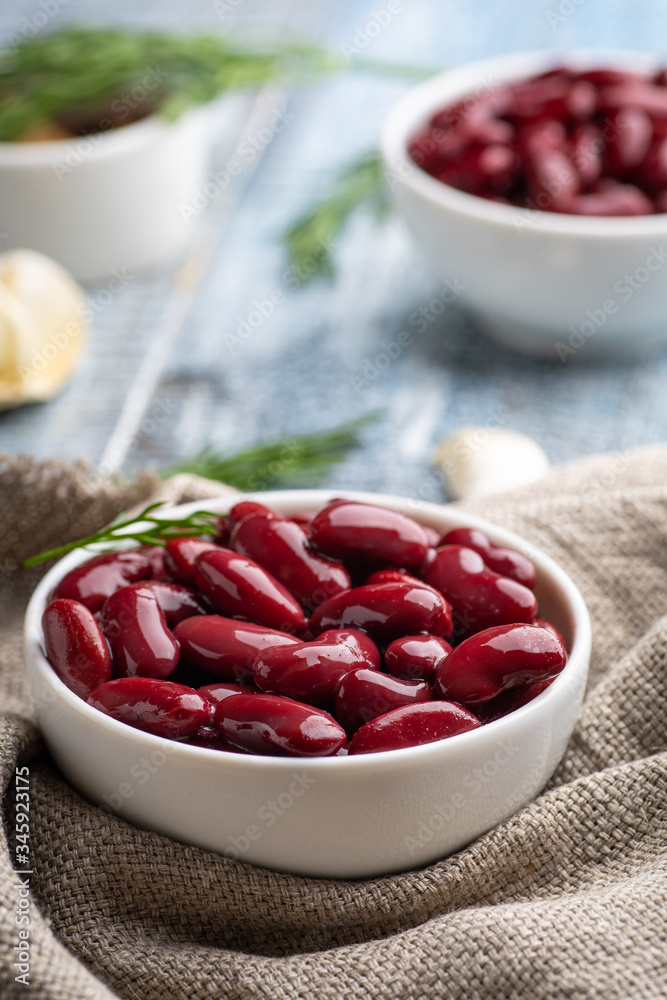 Red kidney beans from can in white bowl on a table. Red kidney beans from can in white bowl on a table.