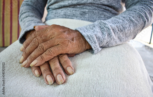  Hand of an old woman withering on his lap