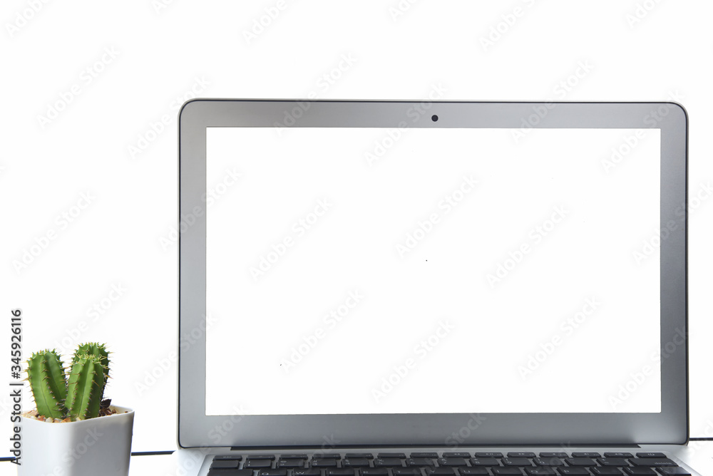 Fototapeta premium White screen computer and cactus plant on the table on white background, copy space input text concept and smart technology idea