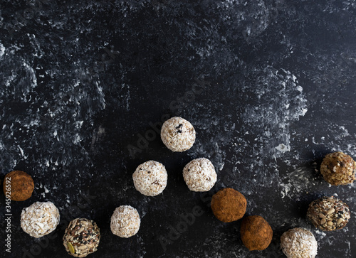 Energy balls on a dark background, place for text, top view.