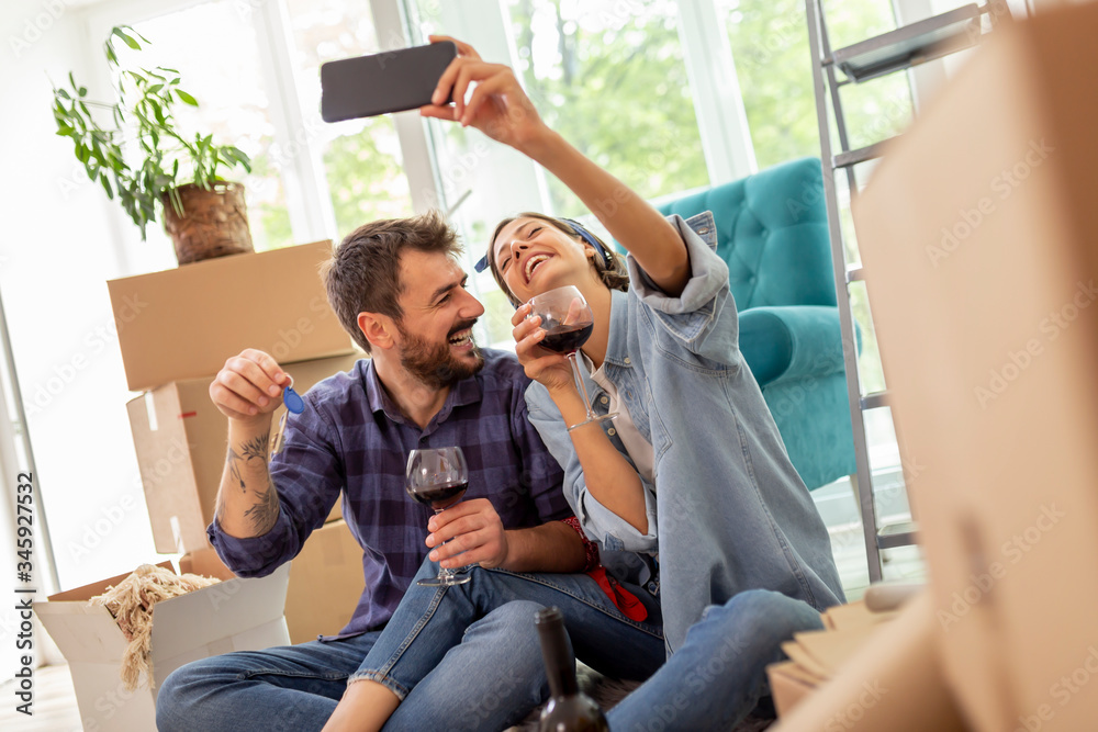 Obraz premium Couple taking selfie in their new home