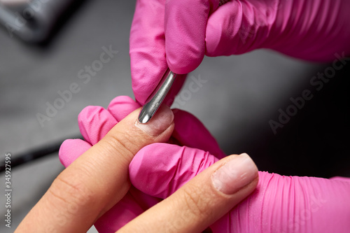 The process of a woman s manicure  gel varnish. Care for the nails  lamp  varnishes  tools  nail covering.