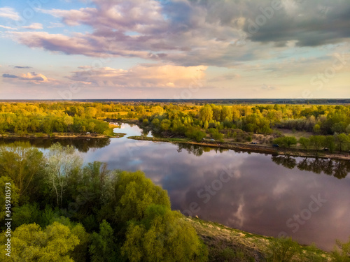 Fototapeta Naklejka Na Ścianę i Meble -  Shot from the drone of the river in which the clouds are reflected