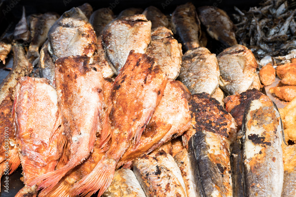 Freshly grilled fish on counter top stall, during seafood festival, street food market.