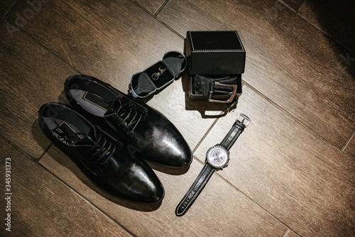 Groom is gathering. Mens shoes, belt, cufflinks, watches