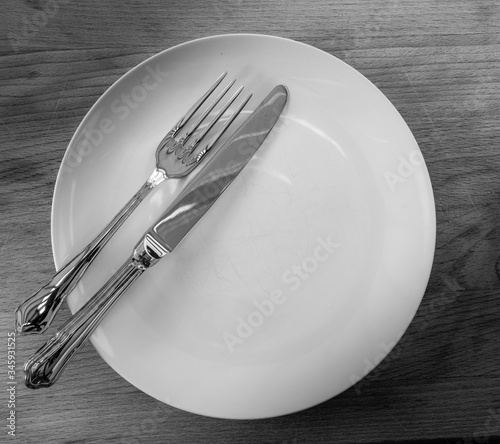 knife fork and plate isolated in black and white