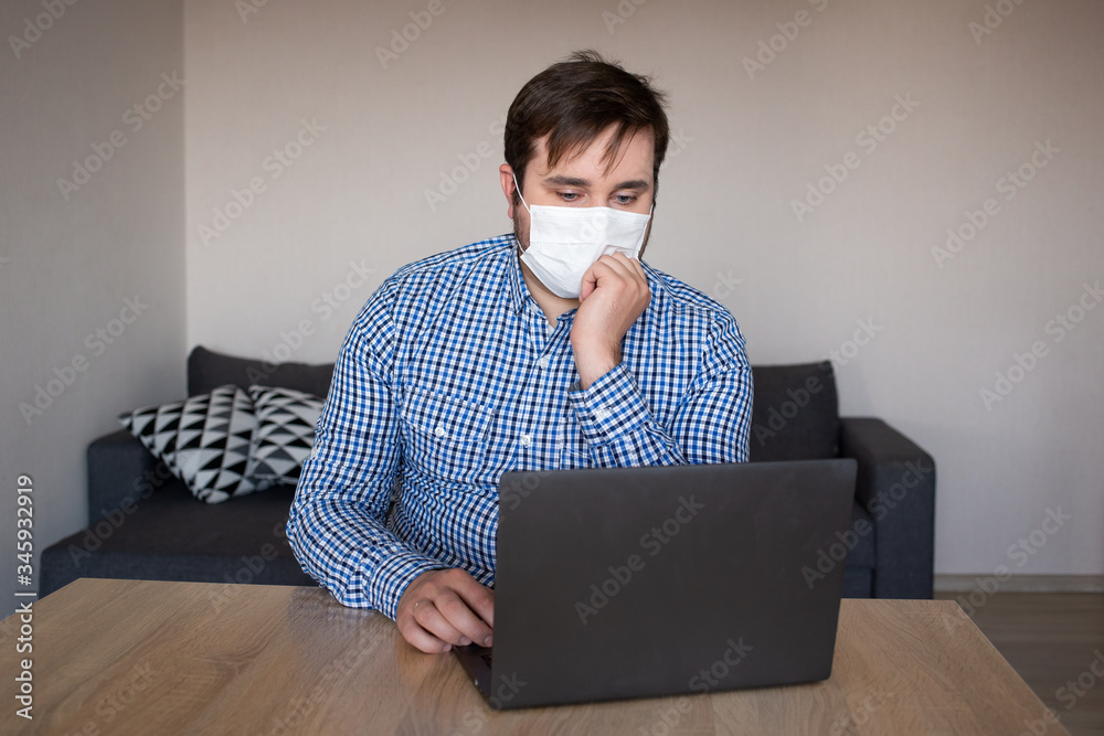 man wearing mask working on his laptop from home , coronavirus, illness, infection, quarantine, medical mask man wearing mask working on his laptop from home , coronavirus, illness, infection, quarantine, medical mask