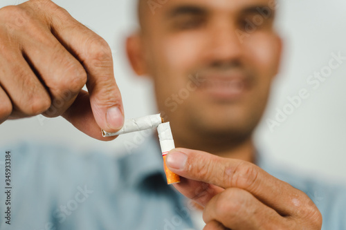 Man hand crushing cigarette, Concept Quitting smoking,World No Tobacco Day. © Suriyawut