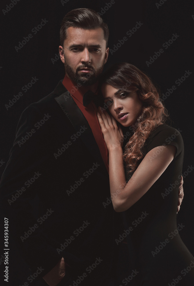 portrait of fashion couple on black background portrait of fashion couple on black background