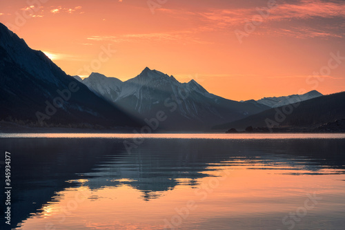 Sunrise on rocky mountains with colorful sky on Medicine Lake, Jasper national park photo