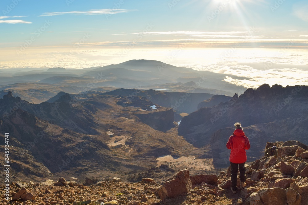 A hiker in the panoramic mountain landscapes of Mount Kenya