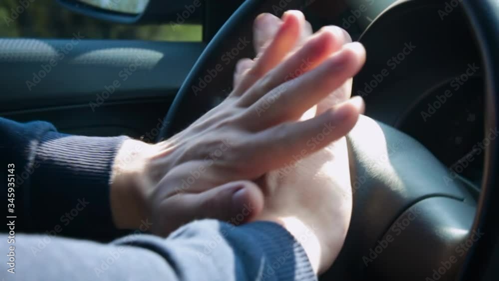 The hand of a man presses on the steering wheel of a car. Nervous unrecognized driver beeping in car. Technology and transportation concepts. The hand of a man presses on the steering wheel of a car. Nervous unrecognized driver beeping in car. Technology and transportation concepts.